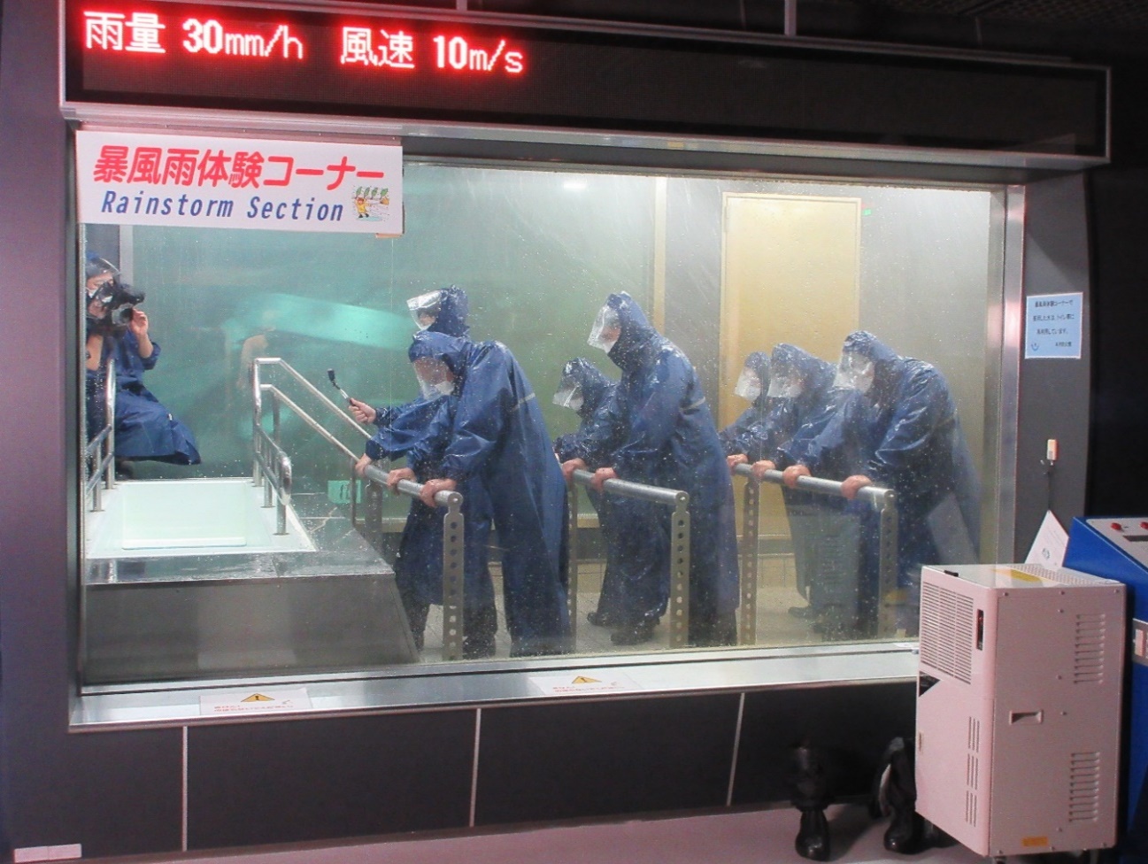 Trainees inside the rainstorm simulation facility in Honjo Life Safety Learning Center.