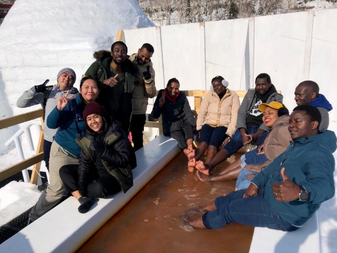 Commemorative photograph of the students enjoying the hot-springs footbath at the Lake Shikaribetsu Kotan. 