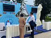 Visitors at our booth holding the brochure that introduces JICA's cooperation projects in the field of disaster risk reduction in Vietnam.