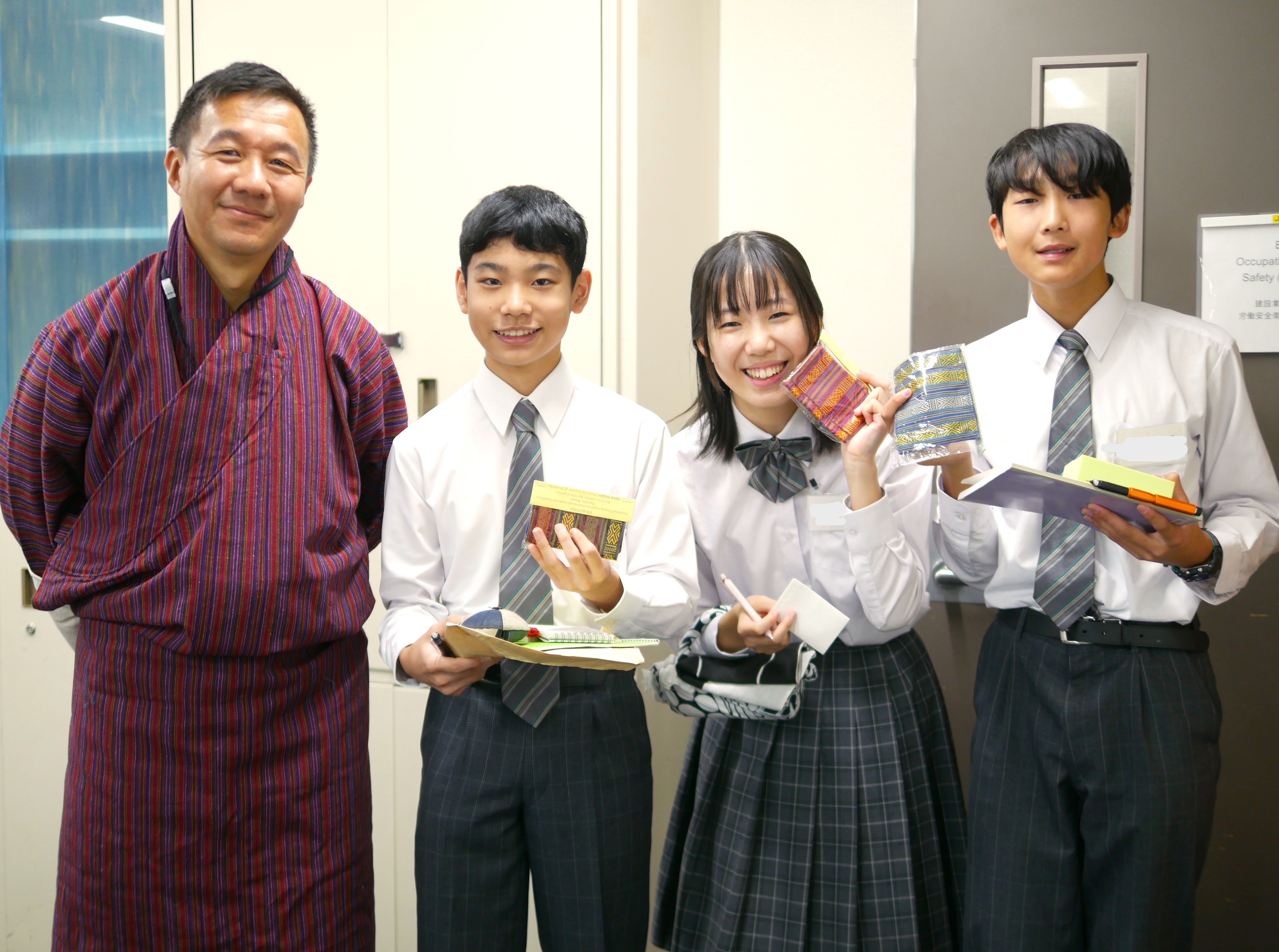 Happy smiles of Japanese students with Bhutanese traditional hand-made souvenirs in hand.