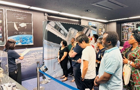JICA long-term participants in a "Regional Understanding Program" receiving explanation about Small Satellite Orbital Deployer at Japan Aerospace Exploration Agency