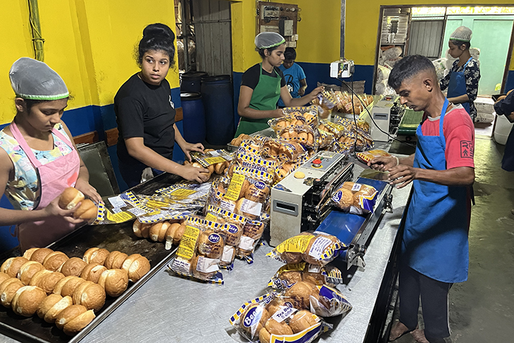 A person with disability is working at a bakery.