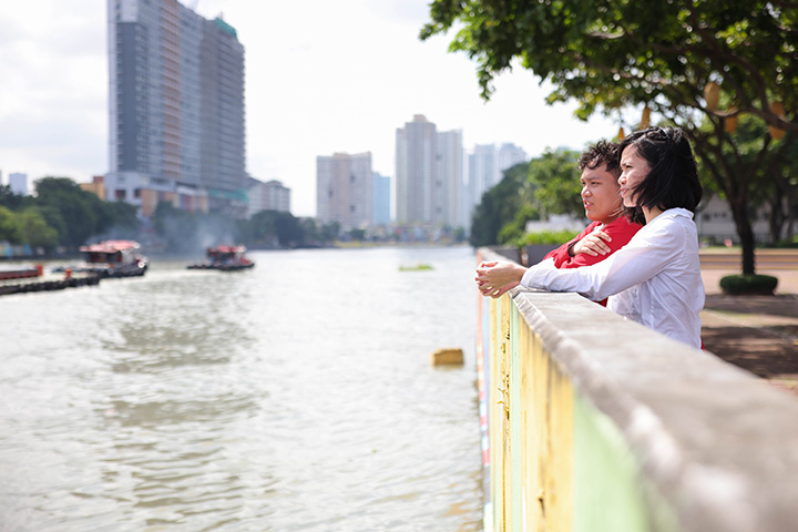 Local people standing by the side of the river