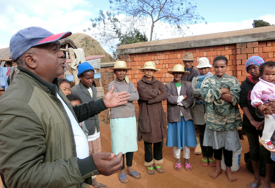 A regional agriculture official describing the seikatsu kaizen activities to local residents.