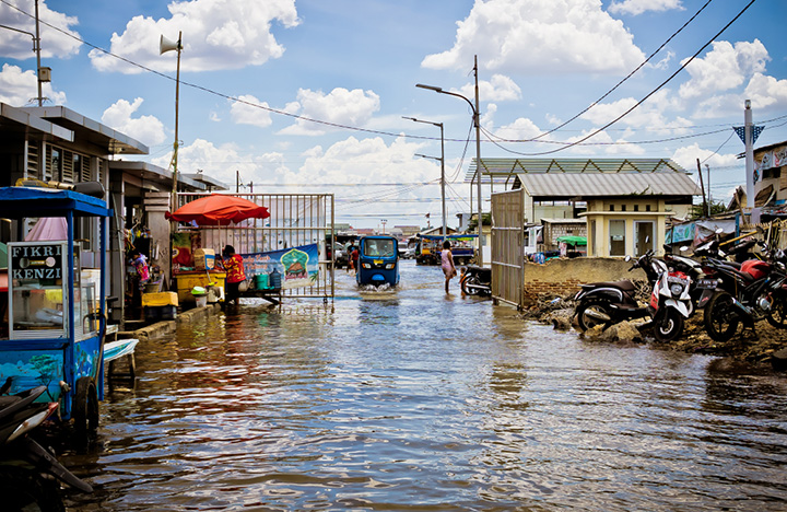 Seawater floods into coastal areas of Jakarta during high tide