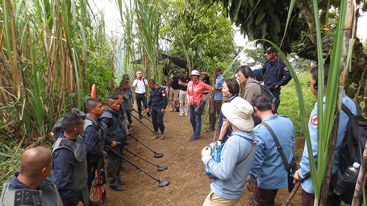 Komukai (center) visiting a demining site in Colombia with CMAC staff