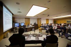 Participants listen to a presenter