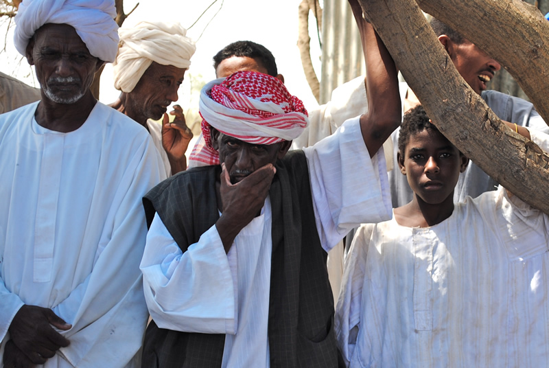 Villagers listen to discussions about repairing their broken water tower