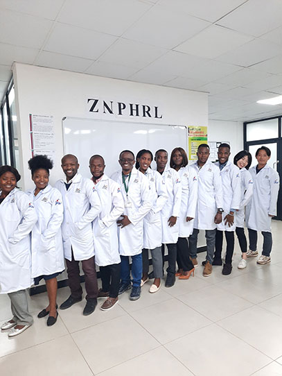 Providing white coat with embroidery of “JICA” and “ZNPHI” to laboratory technicians.