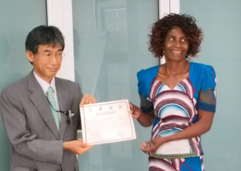 Receiving a certificate for rice training course completion.