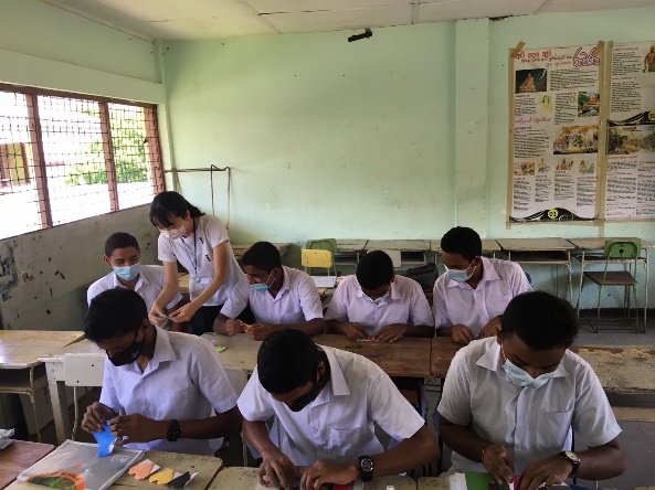 An origami class held at a visited school.