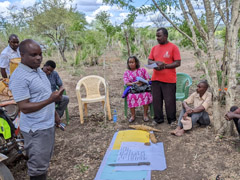 Extension officer (left) listening to farmers' opinions