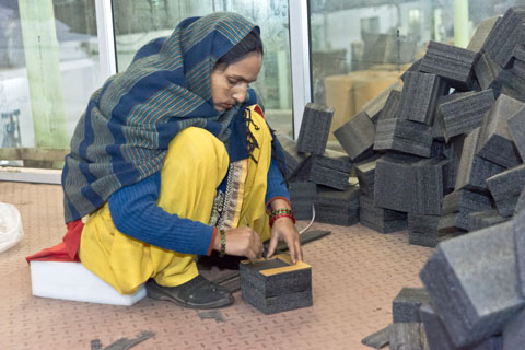 JICAで機材支援をした段ボール工場で資材を作る女性