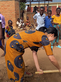 Ploughing the schoolyard with children.