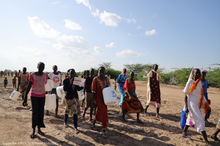 国連難民高等弁務官事務所（UNHCR）から支給されたポリタンクを手に水くみに行く女性たち